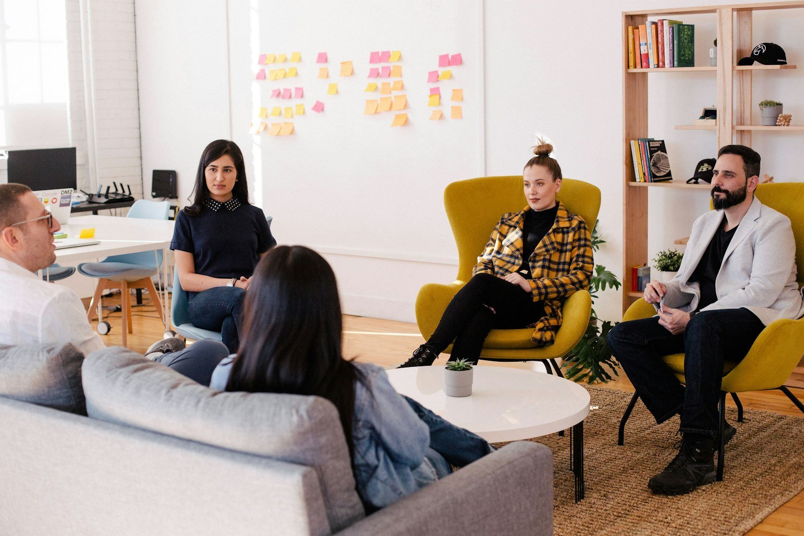 Small group of professionals continuing a relaxed discussion after a workshop