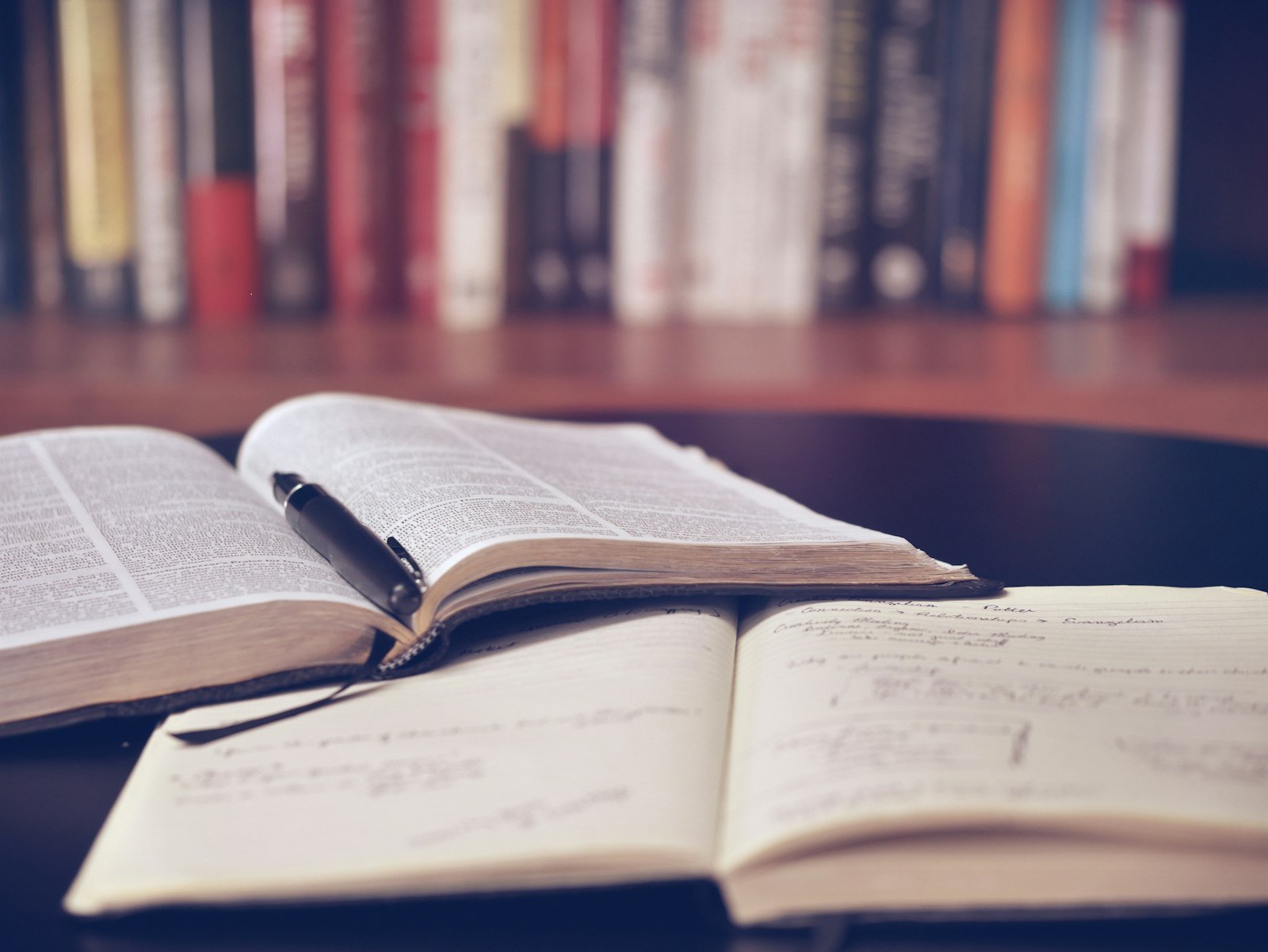 Open books and a notebook with handwritten study notes